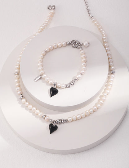 Classic Pearl Bracelet with Black Heart Charm - A Modern Twist